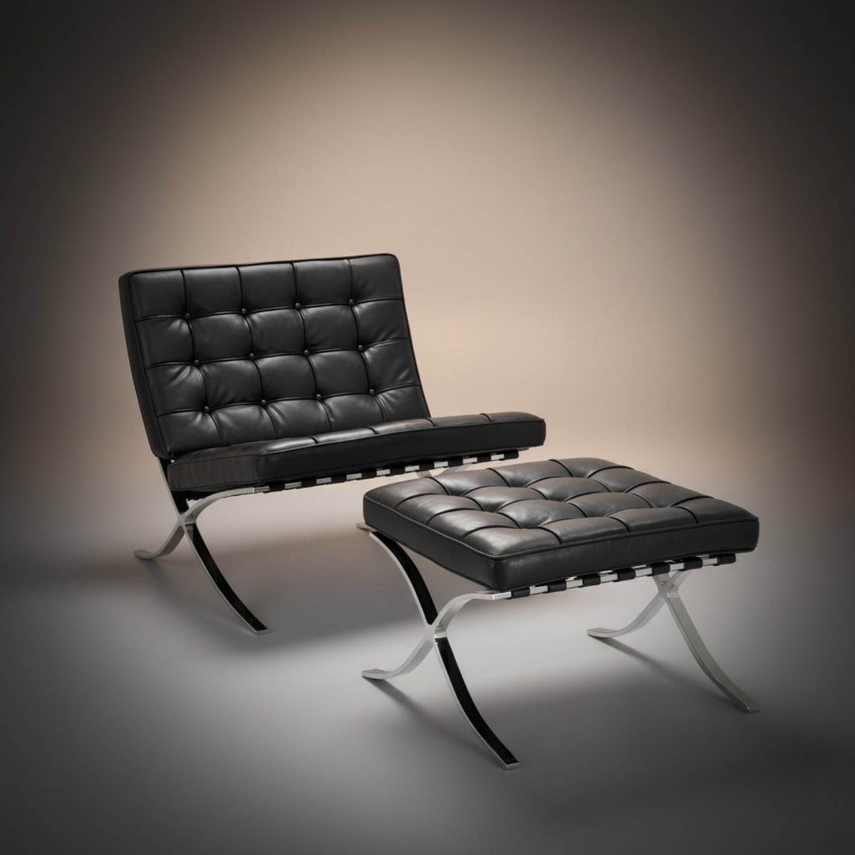 A modern black leather tufted lounge chair with a matching ottoman, both supported by curved silver metal legs