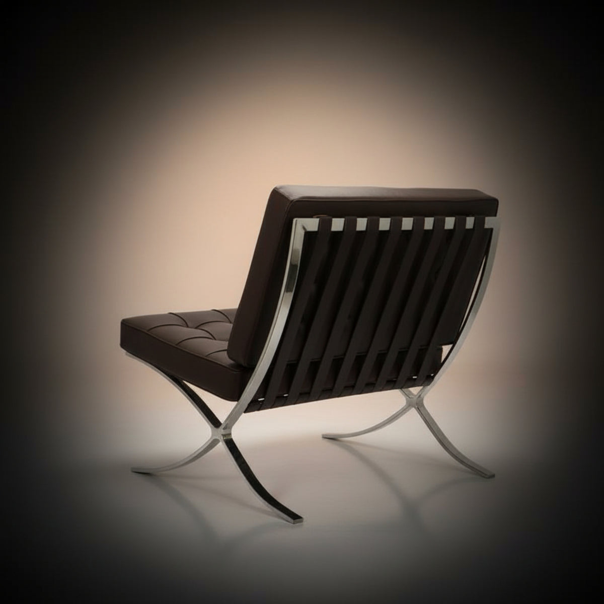 A modern leather and metal lounge chair shown from the back, featuring a dark brown tufted seat and backrest