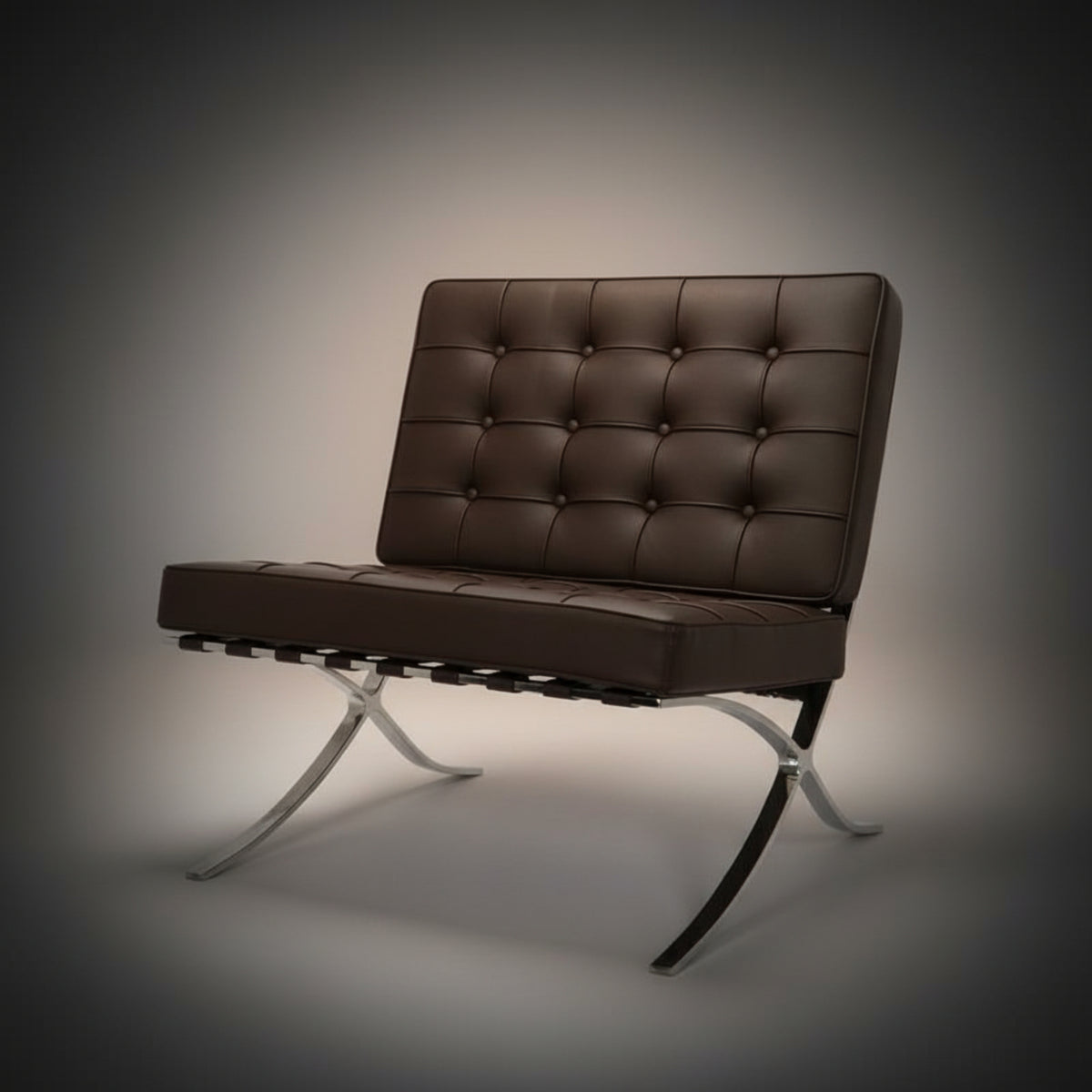 A modern armchair with a tufted brown leather seat and backrest, supported by a chrome and black metal X-frame base