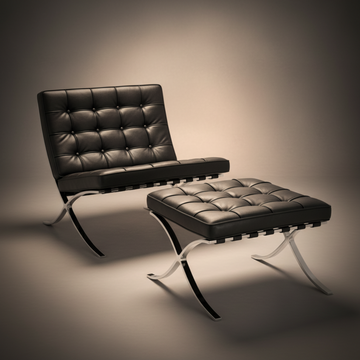 A modern black leather tufted armchair with a matching ottoman, both supported by curved silver metal legs