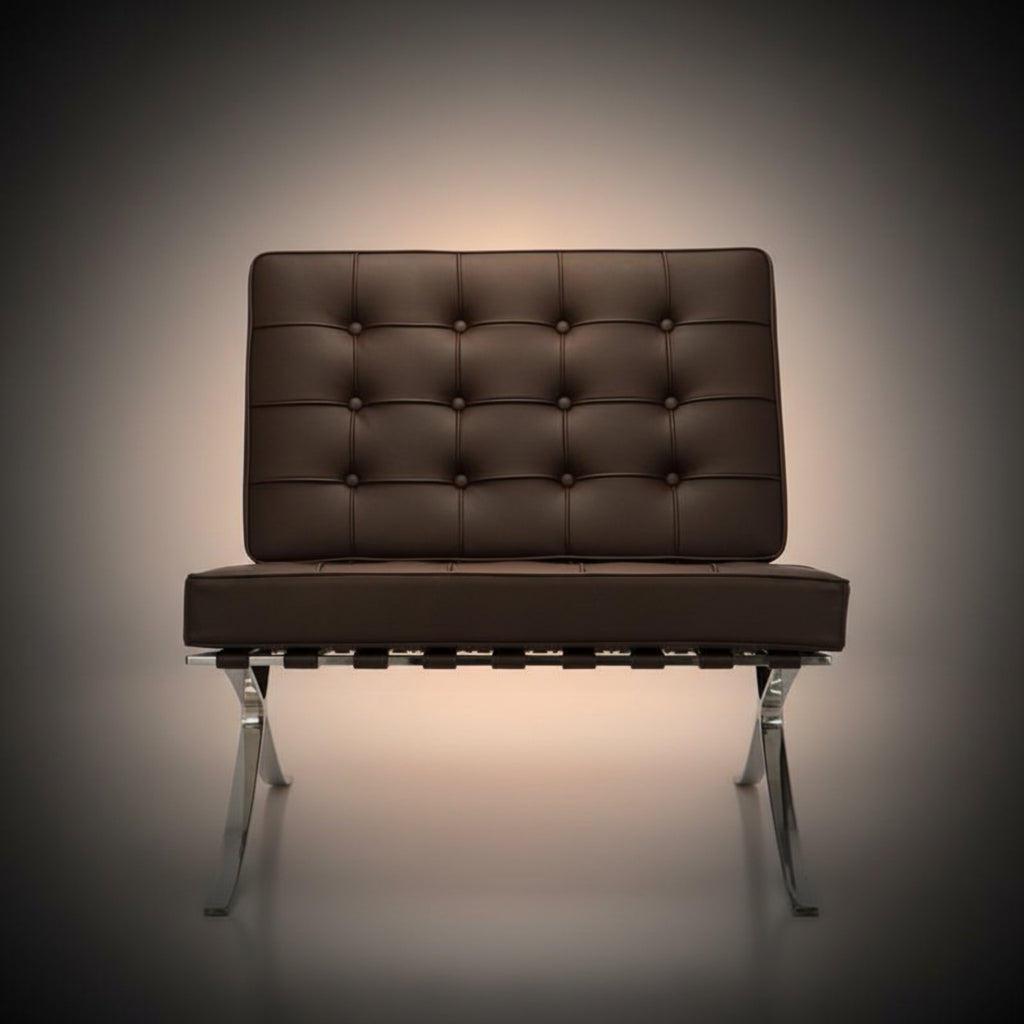 A modern tufted leather armchair with a brown cushioned backrest and seat, supported by a chrome metal