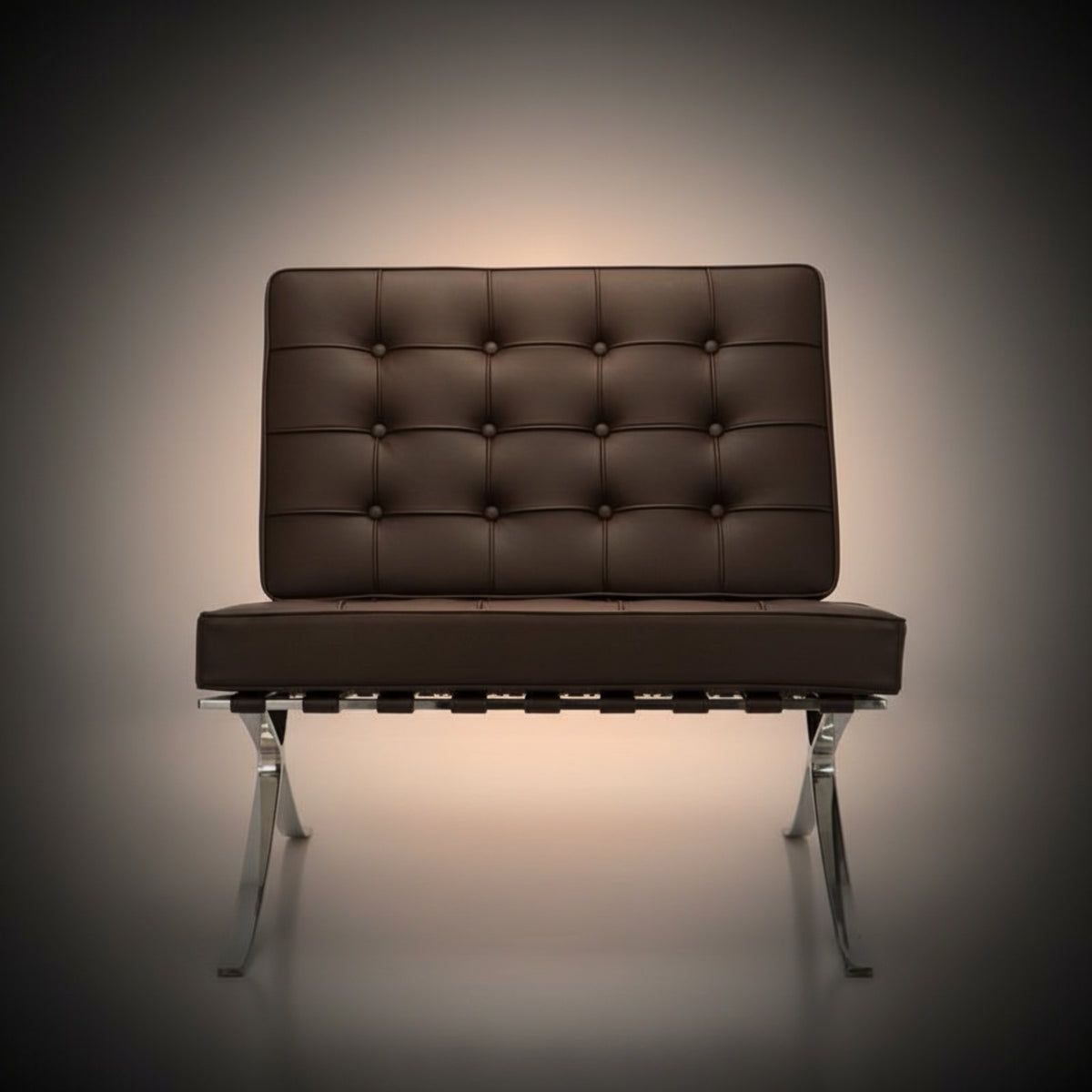 A modern tufted leather armchair with a brown cushioned backrest and seat, supported by a chrome metal
