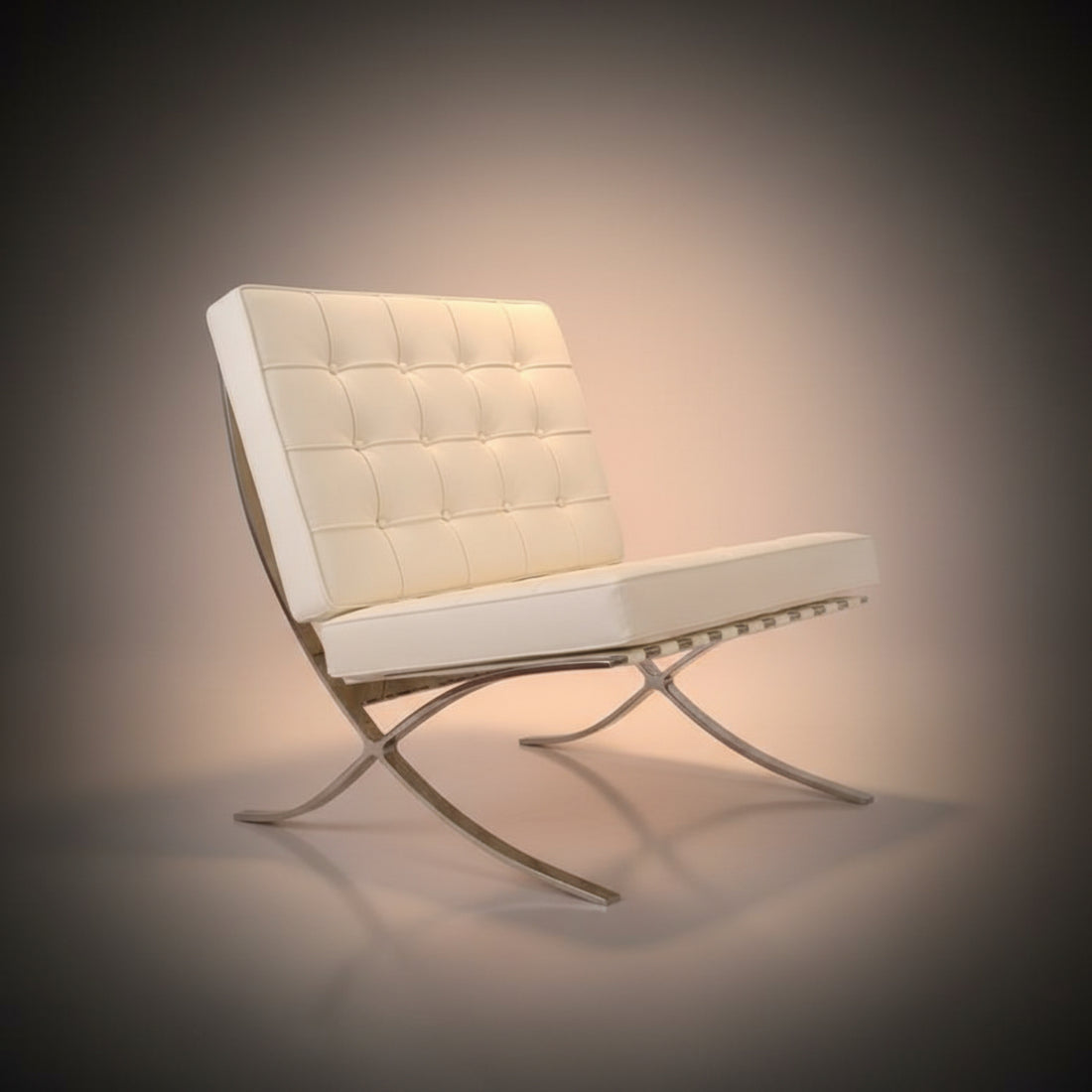 A modern tufted lounge chair with a matching ottoman, upholstered in off-white leather with polished chrome S-shaped legs