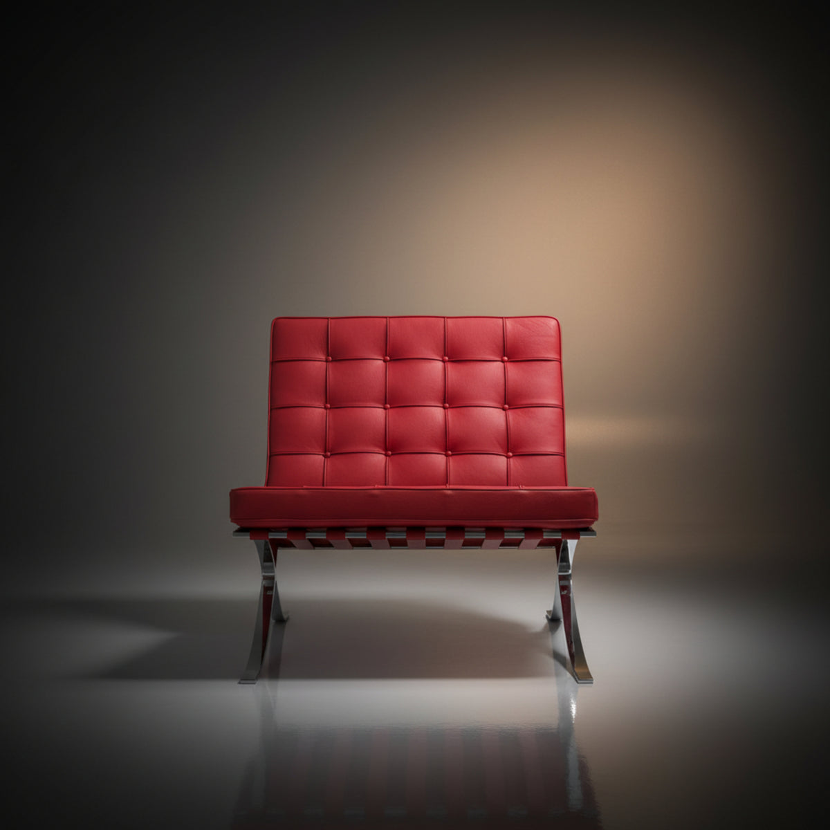 A modern red tufted leather armchair with a chrome metal base, centered against a dark gray studio