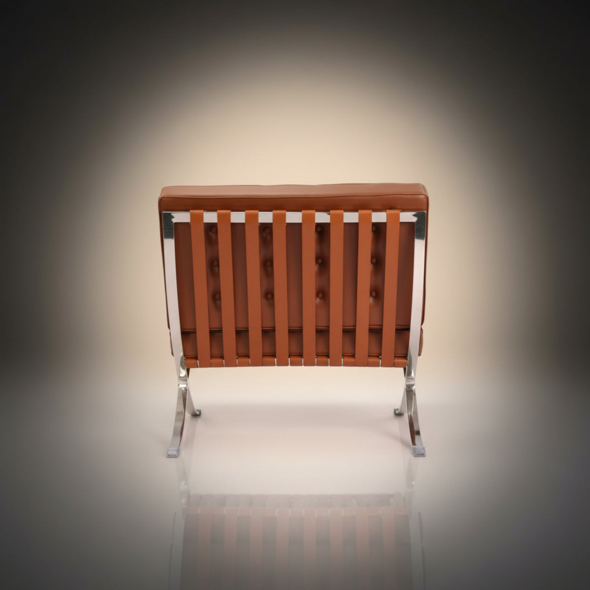A modern armless lounge chair with a tufted brown leather backrest and backrest frame, supported by a chrome steel frame with splayed legs
