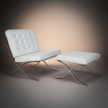 A modern white tufted lounge chair with a matching ottoman, both featuring curved silver metal legs.