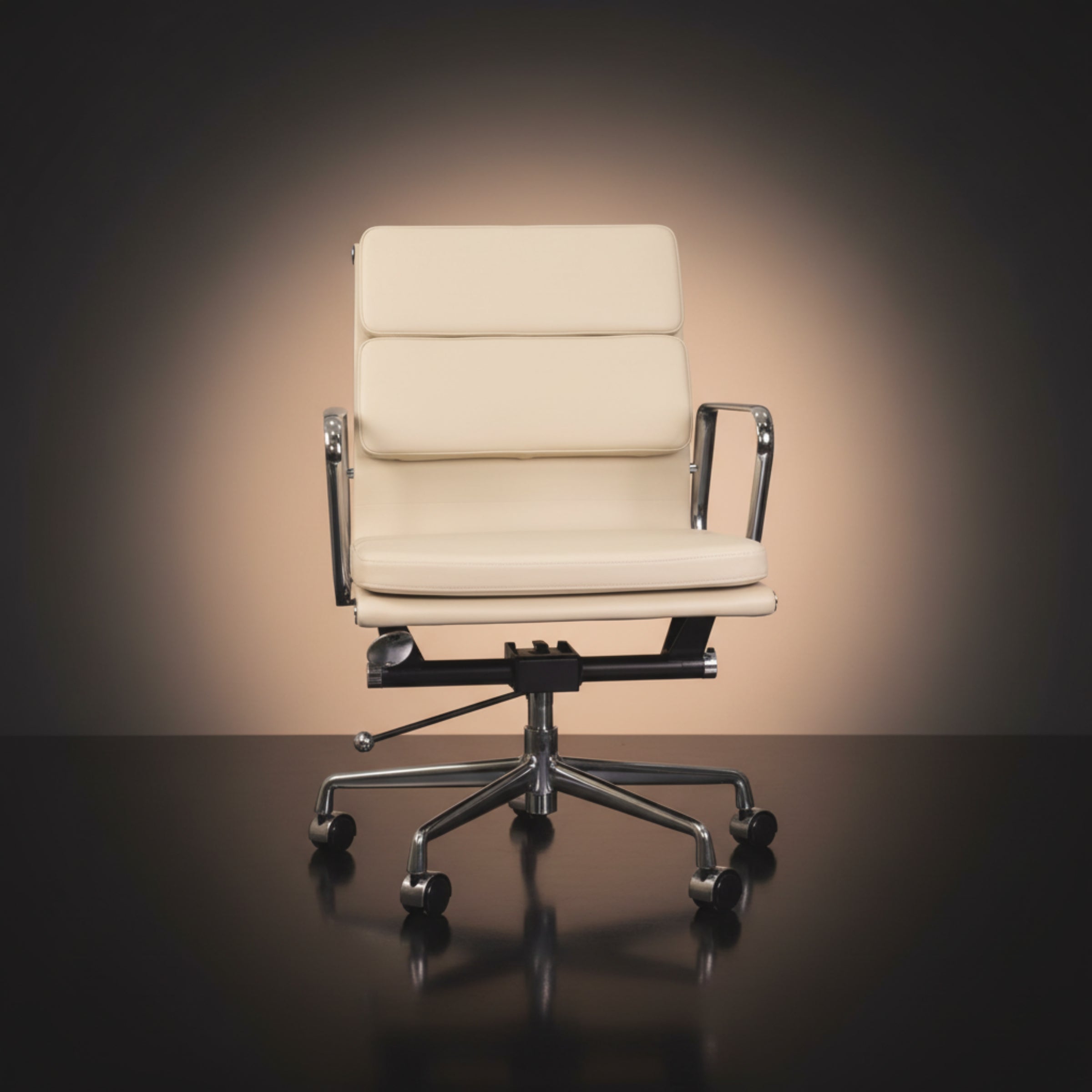 An off-white leather office chair with a high segmented backrest and chrome armrests Eames_Insired_Soft_Pad_Ea217_Soft_Pad_Ivory_White_1