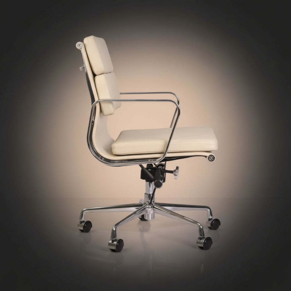 A modern office chair with cream-colored padded seat and backrest, supported by a polished chrome five-star base 