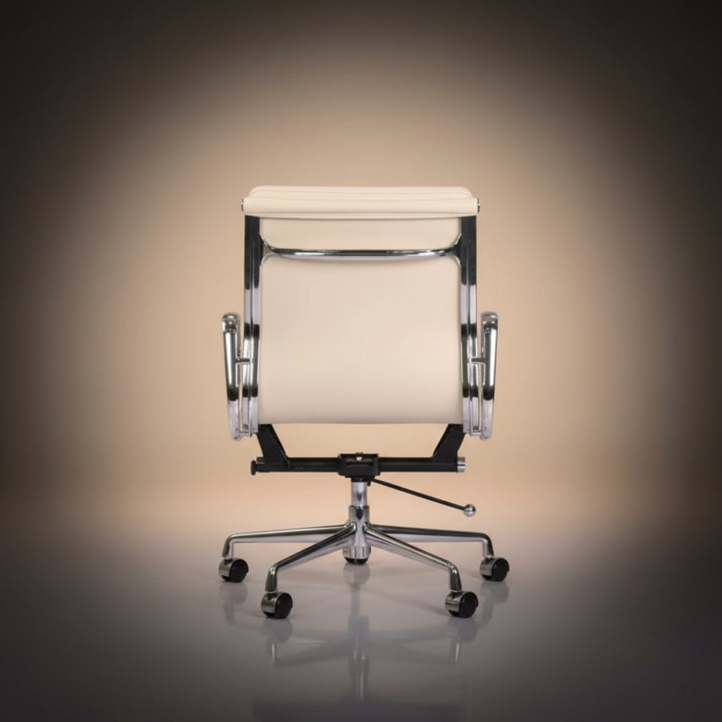 A modern office chair with a cream-colored upholstered seat and backrest, supported by a chrome five-star base with casters