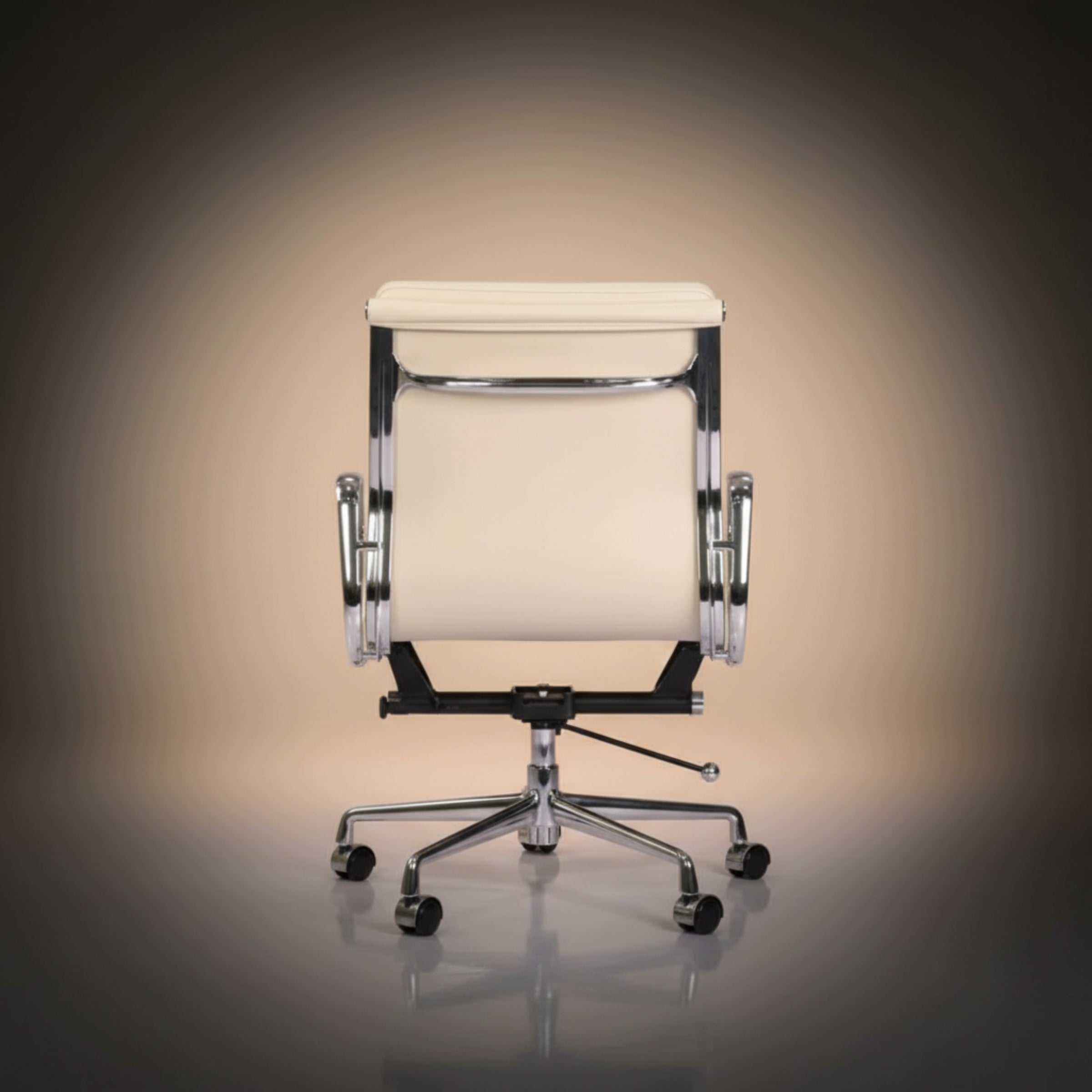 A modern office chair with a cream-colored upholstered seat and backrest, supported by a chrome five-star base with casters