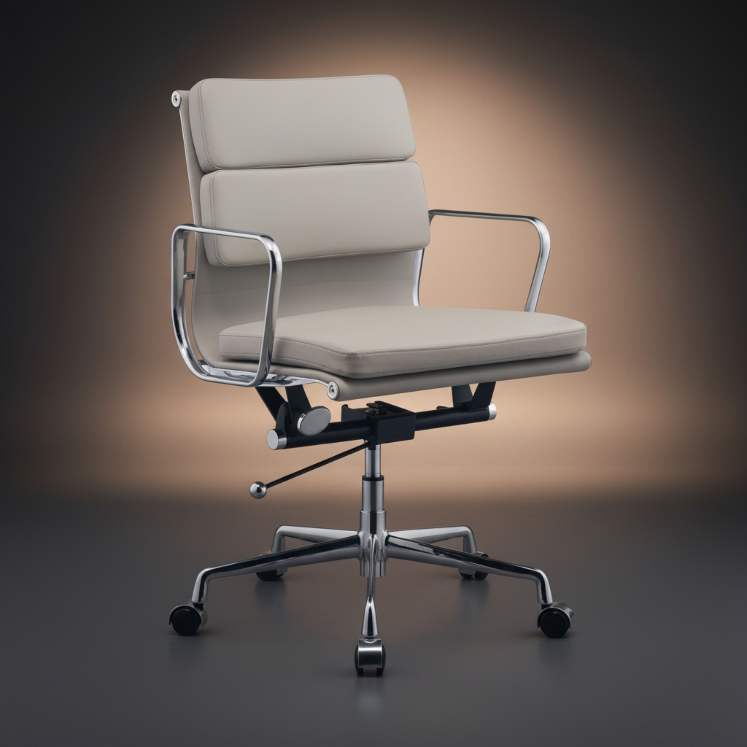 A modern office chair with cream-colored padded upholstery and a polished chrome five-star base 