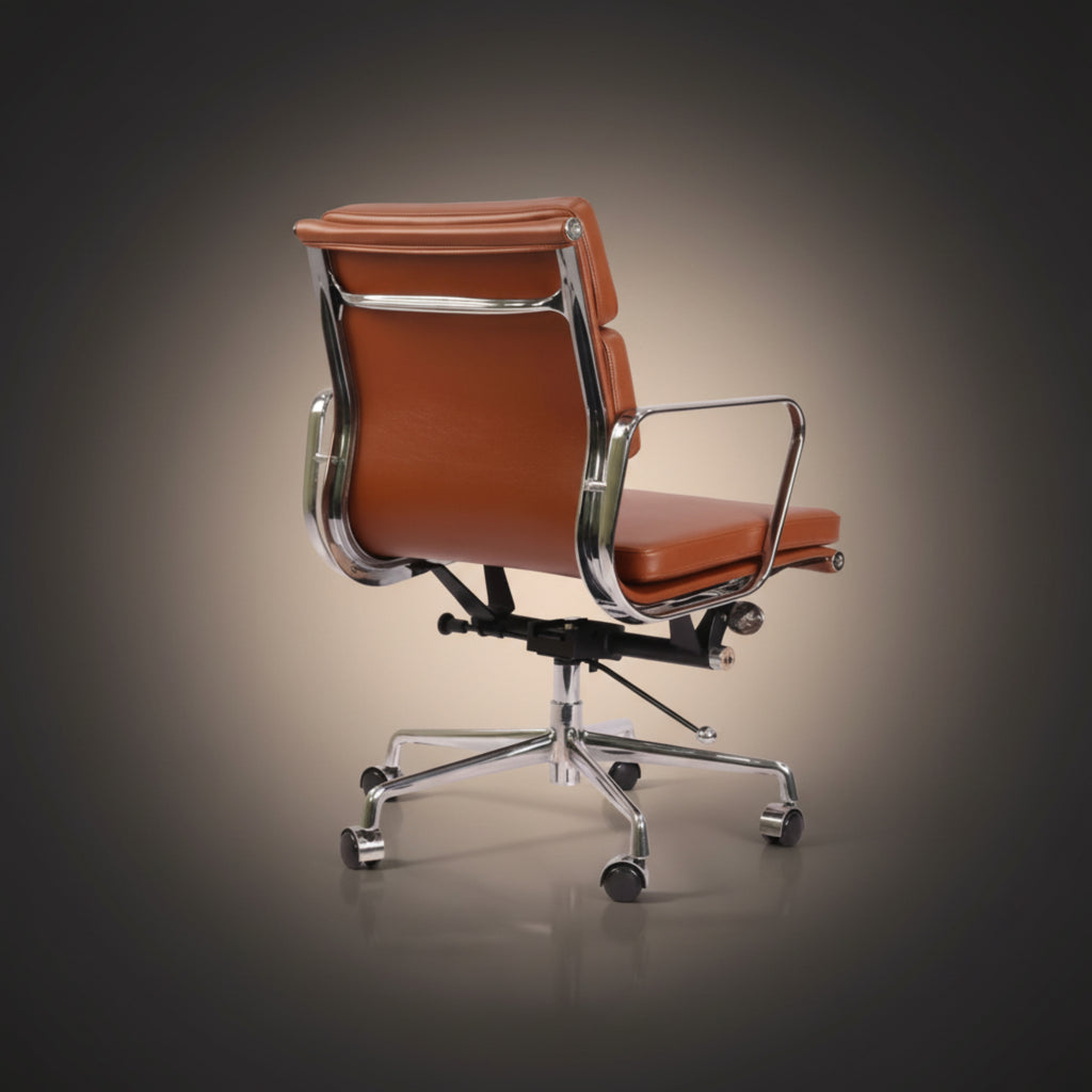 A modern office chair with brown leather upholstery and polished chrome metal frame and base