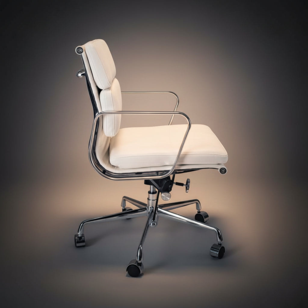 A modern office chair with cream-colored padded upholstery and a polished chrome metal frame