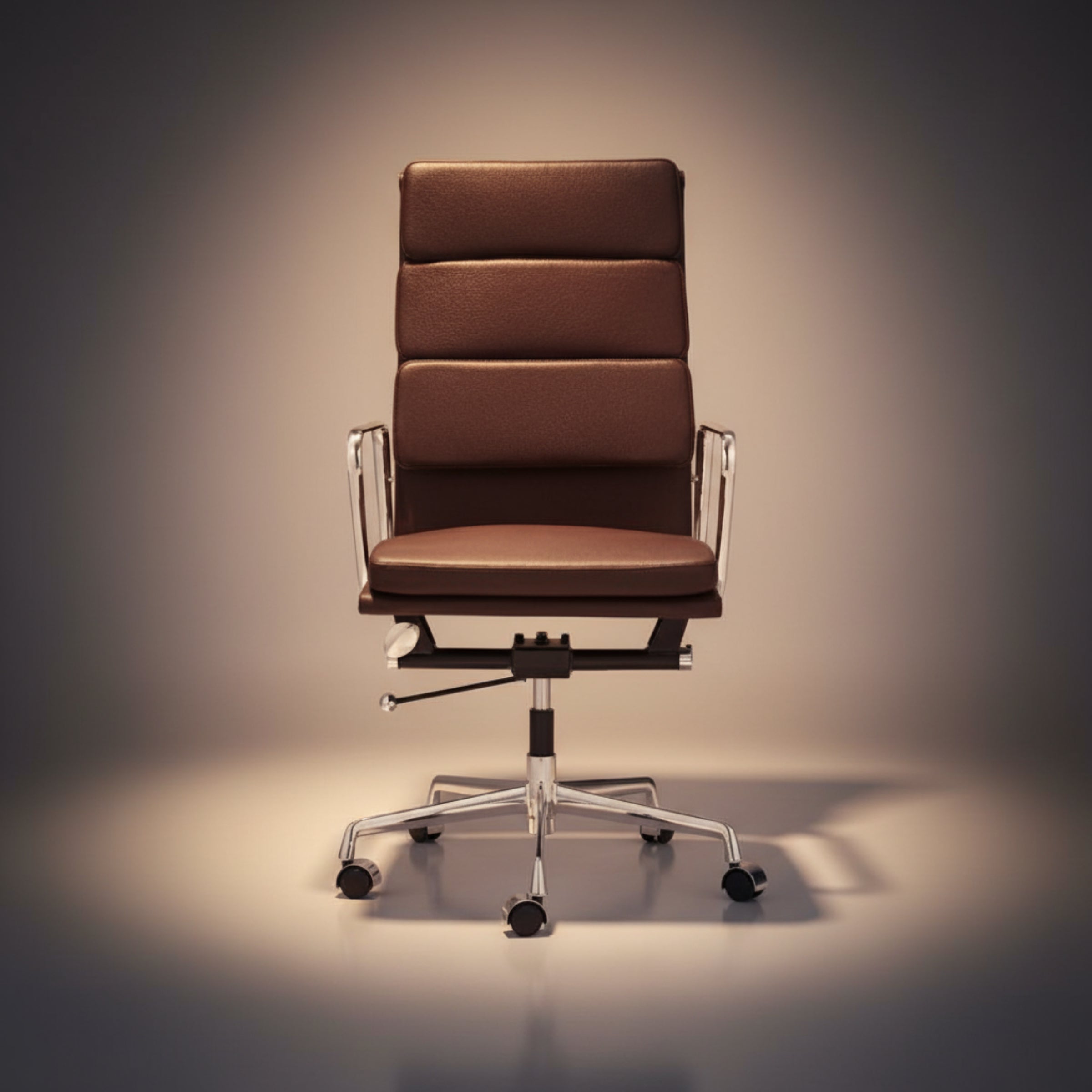 A modern high-back office chair with brown padded upholstery and a chrome five-star base, photographed against a dark gradient studio background.