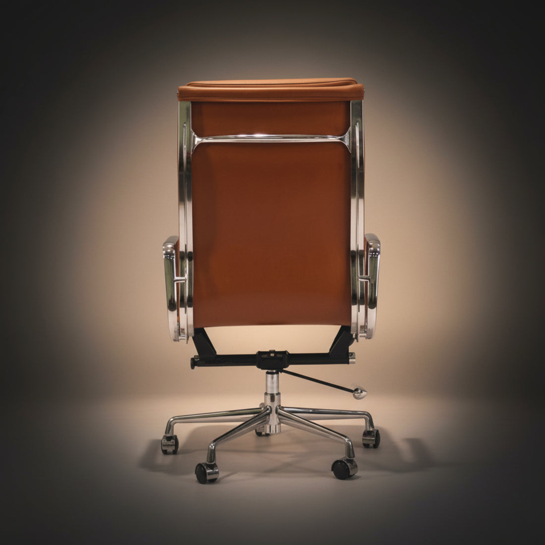 A modern high-back office chair with brown leather upholstery and a chrome-finished metal frame and five-wheel base