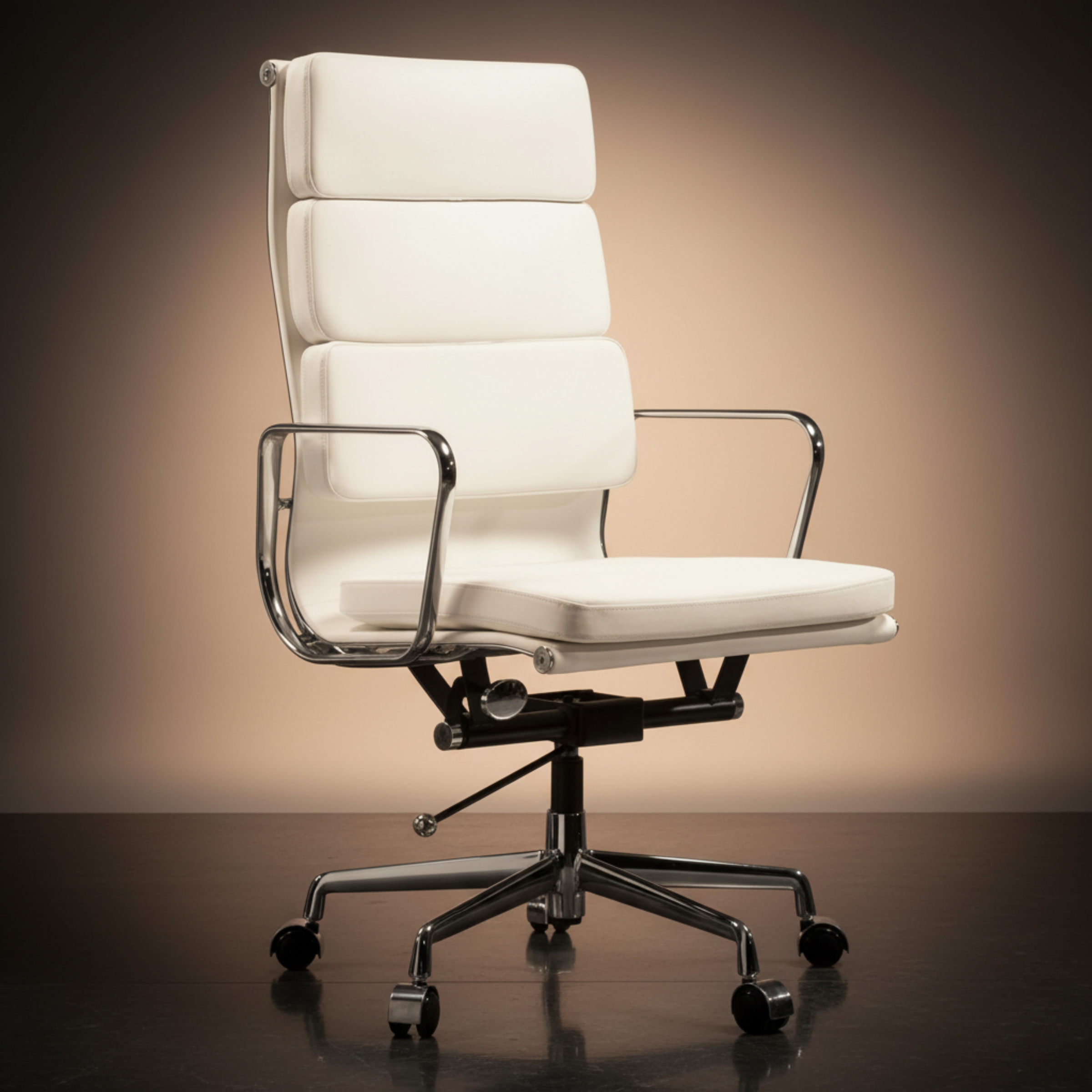A modern high-back office chair with white padded upholstery and chrome metal armrests and base