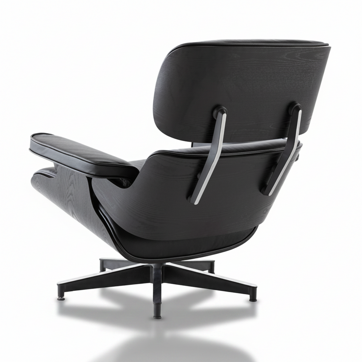 A modern black leather and wood lounge chair with a five-star base