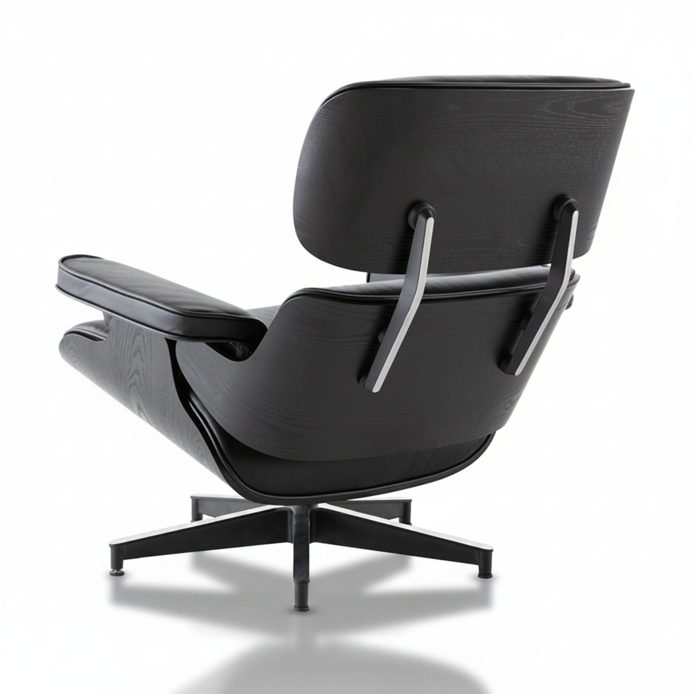A modern black leather and wood lounge chair with a five-star base