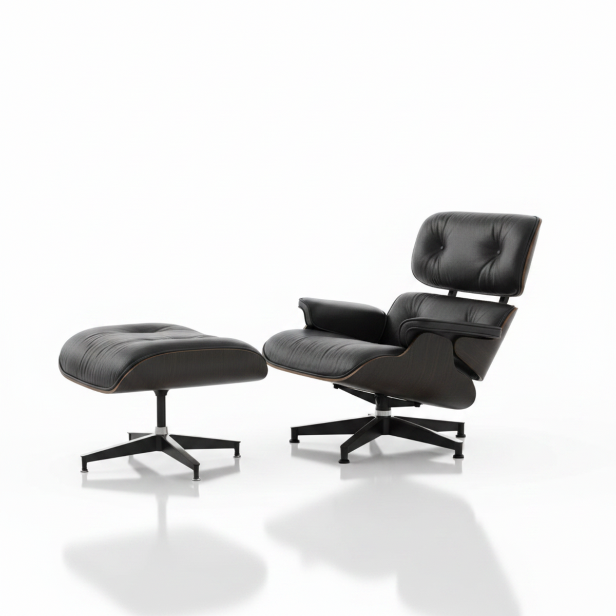 Black leather lounge chair and ottoman on a white background