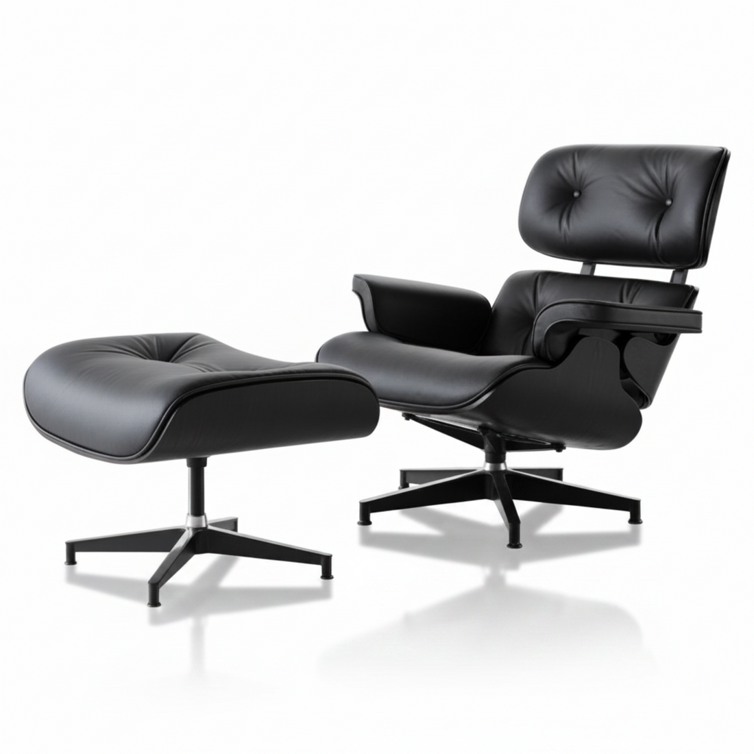 Black leather lounge chair and ottoman on a white background