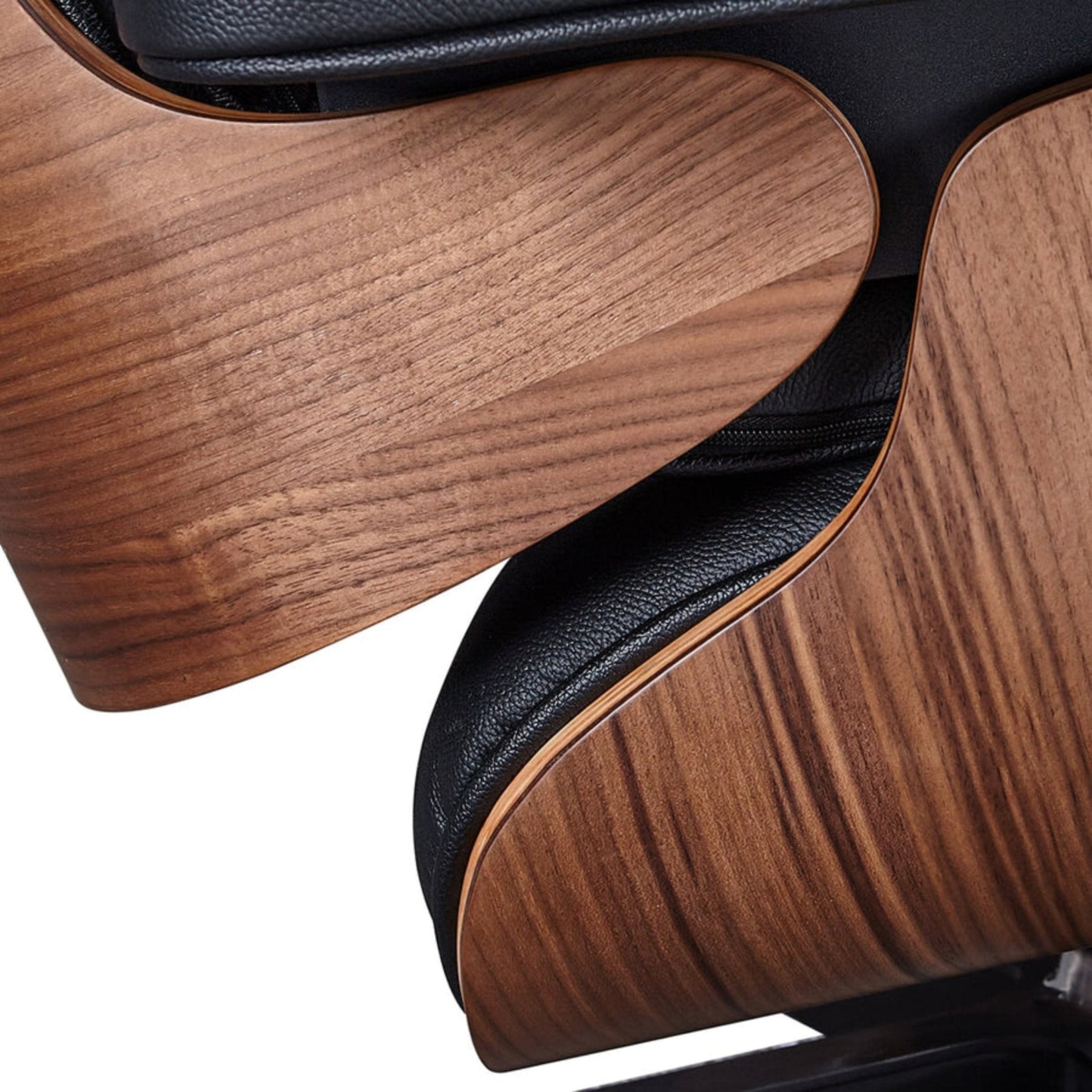 Close-up of a wooden chair with black leather accents