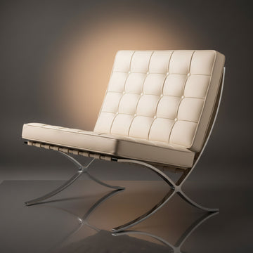 A modern tufted leather armchair with a chrome metal frame, shown on a dark gray reflective studio