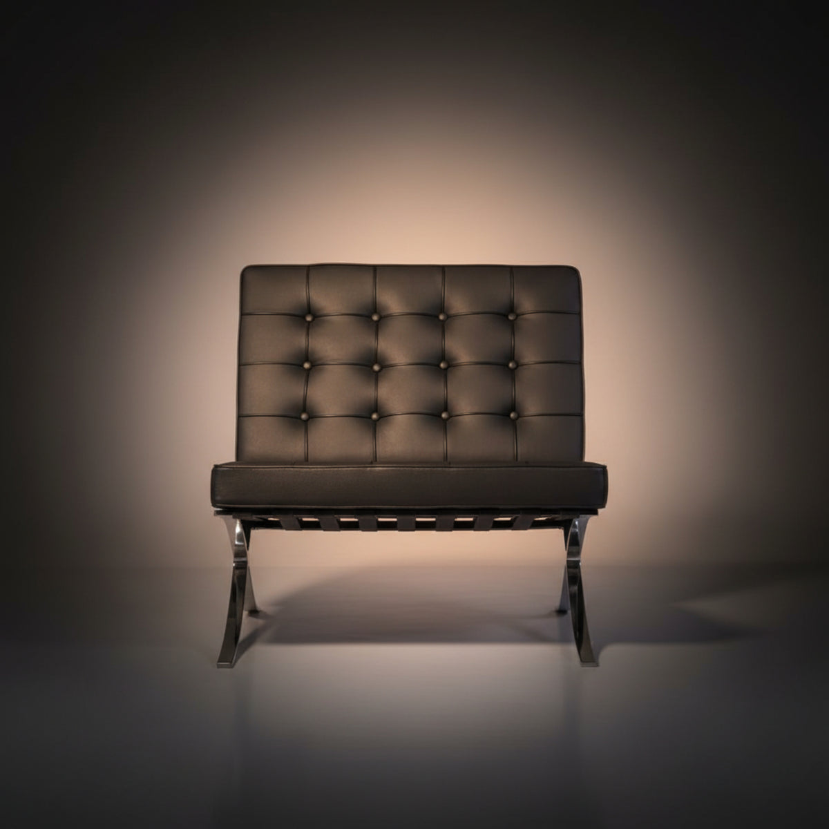A modern armless lounge chair with a tufted dark brown leather backrest and seat, supported by a chrome metal frame
