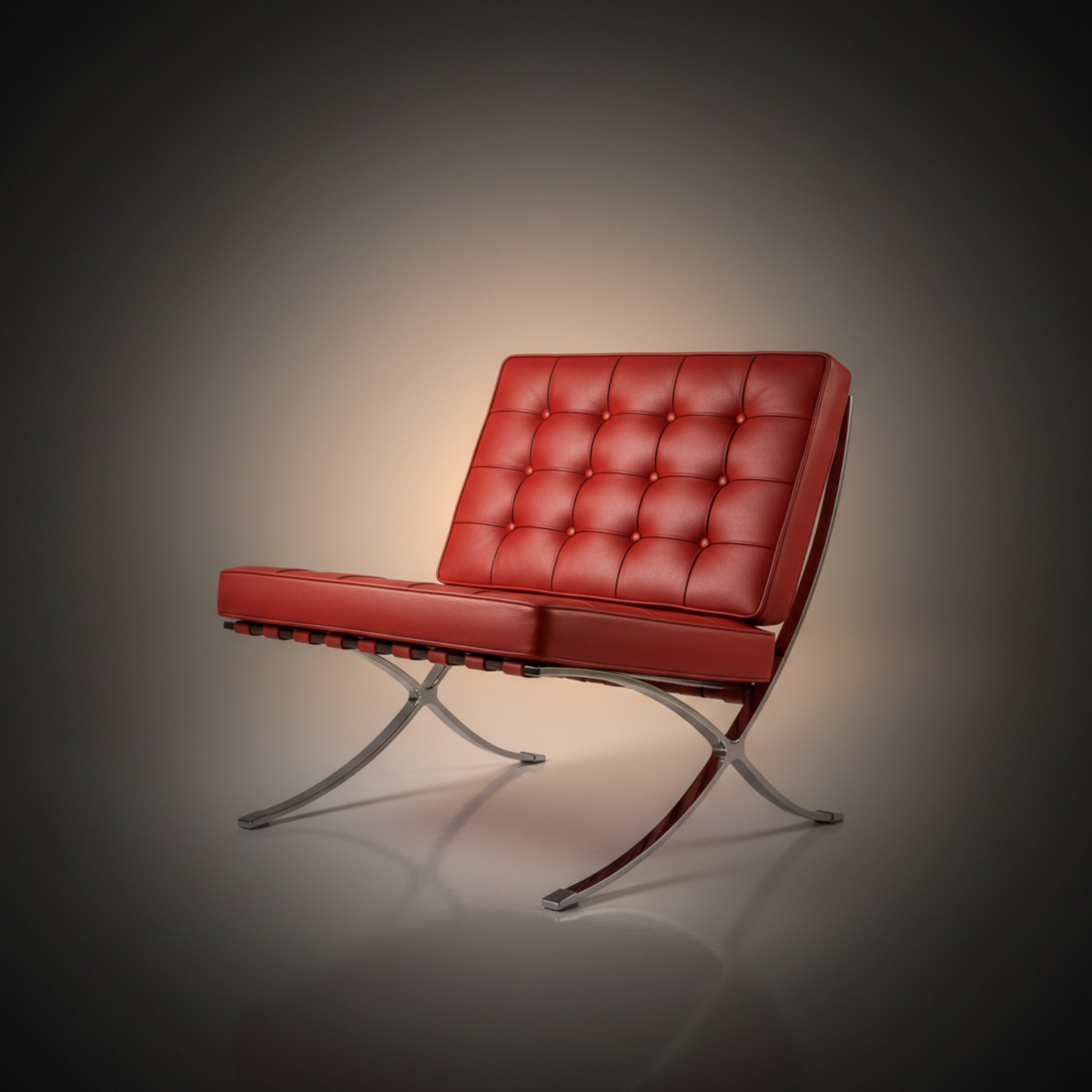 A modern red tufted leather armchair with a chrome S-shaped metal base, shown against a dark gray vignette background.