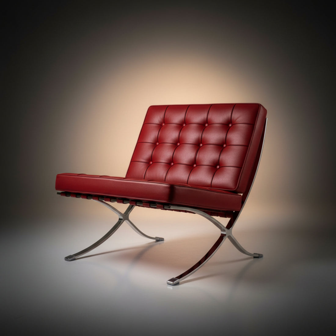 A modern Barcelona-style armchair with deep tufted red leather upholstery and curved chrome metal legs