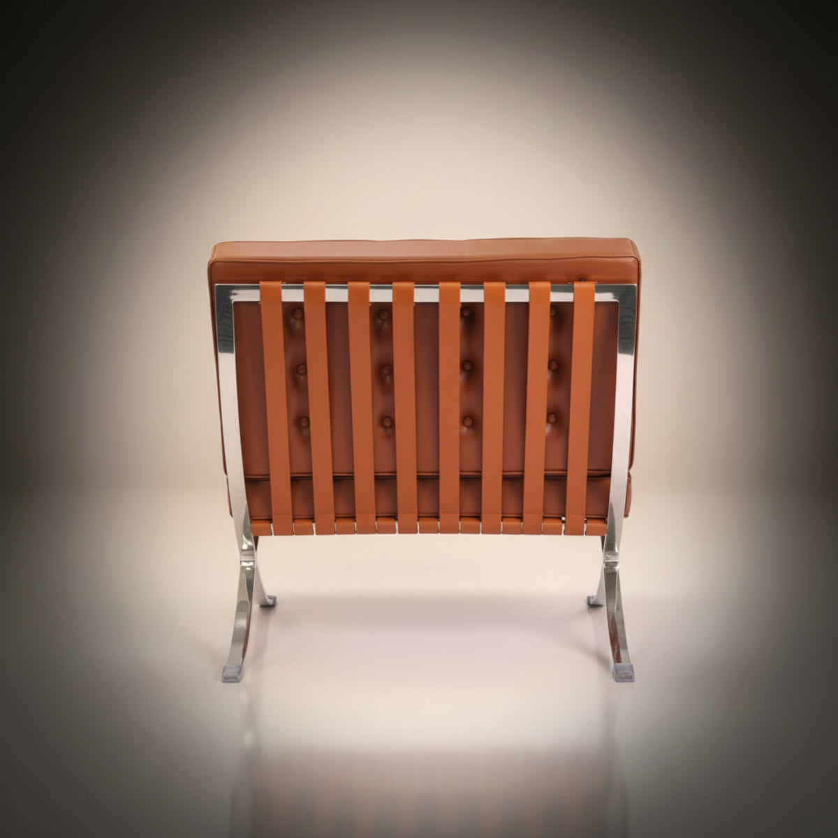 A modern lounge chair with a tufted brown leather backrest, vertical leather seat slats, and a chrome metal frame and legs