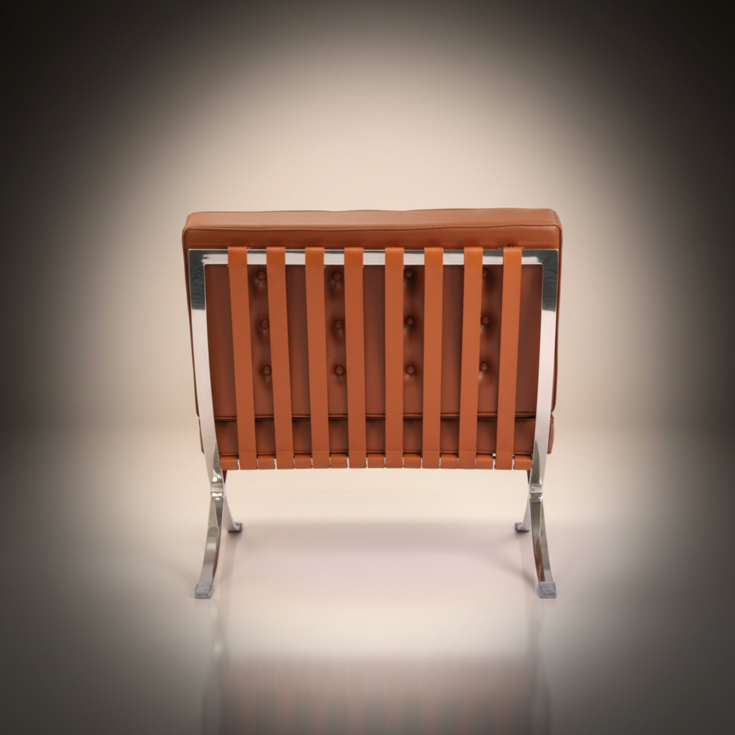 A modern lounge chair with a tufted brown leather backrest, vertical leather seat slats, and a chrome metal frame and legs