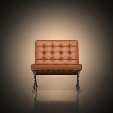 A modern leather armchair with a tufted backrest and chrome legs, centered