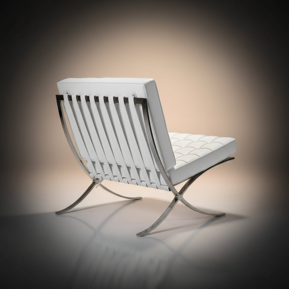 A modern white leather lounge chair with a curved chrome metal frame, shown from a three-quarters angle against