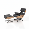A classic mid-century modern lounge chair with matching ottoman, featuring black leather upholstery