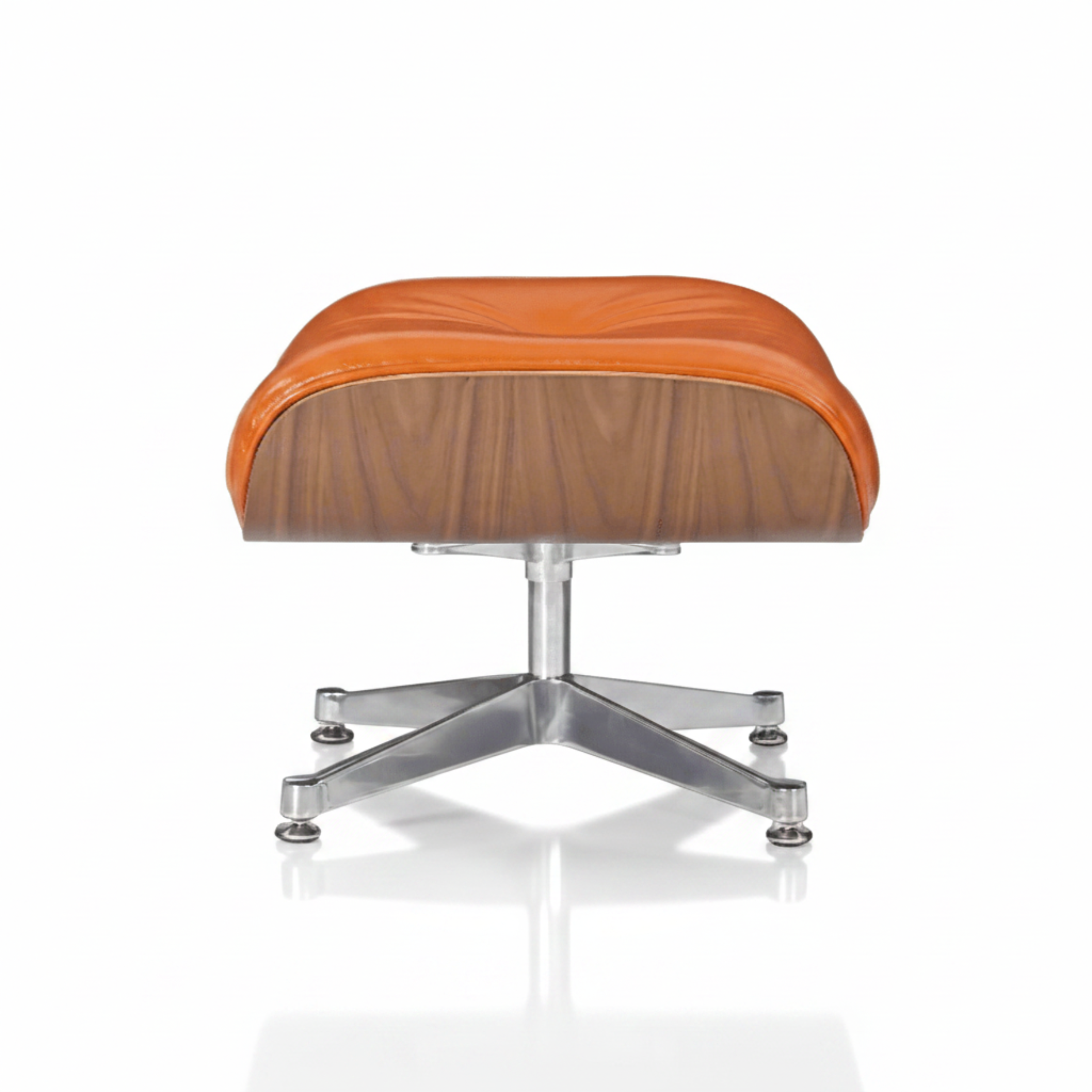 An Eames-style lounge chair and ottoman set with a warm orange-brown leather seat, a wood-grain shell, and a chrome metal base, shown on a white background with a soft reflection.