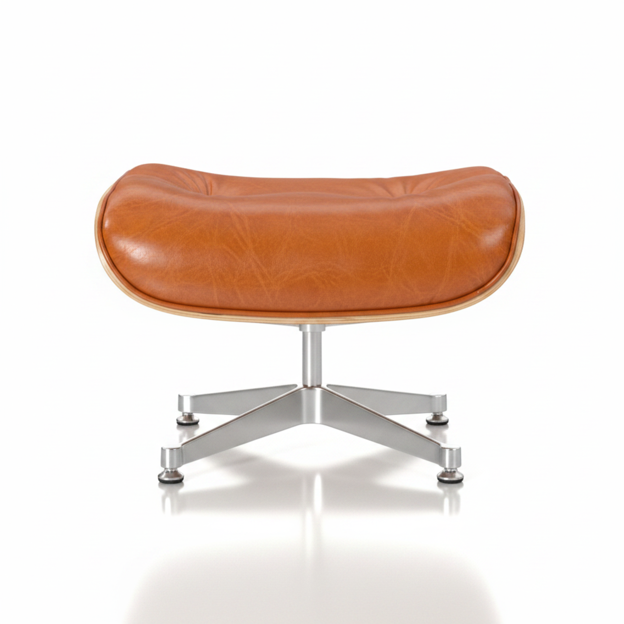 An orange leather lounge chair ottoman with a curved cushioned seat and a chrome five-star base, shown against a neutral gray background.