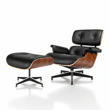 Black leather lounge chair and ottoman with wooden accents on a white background