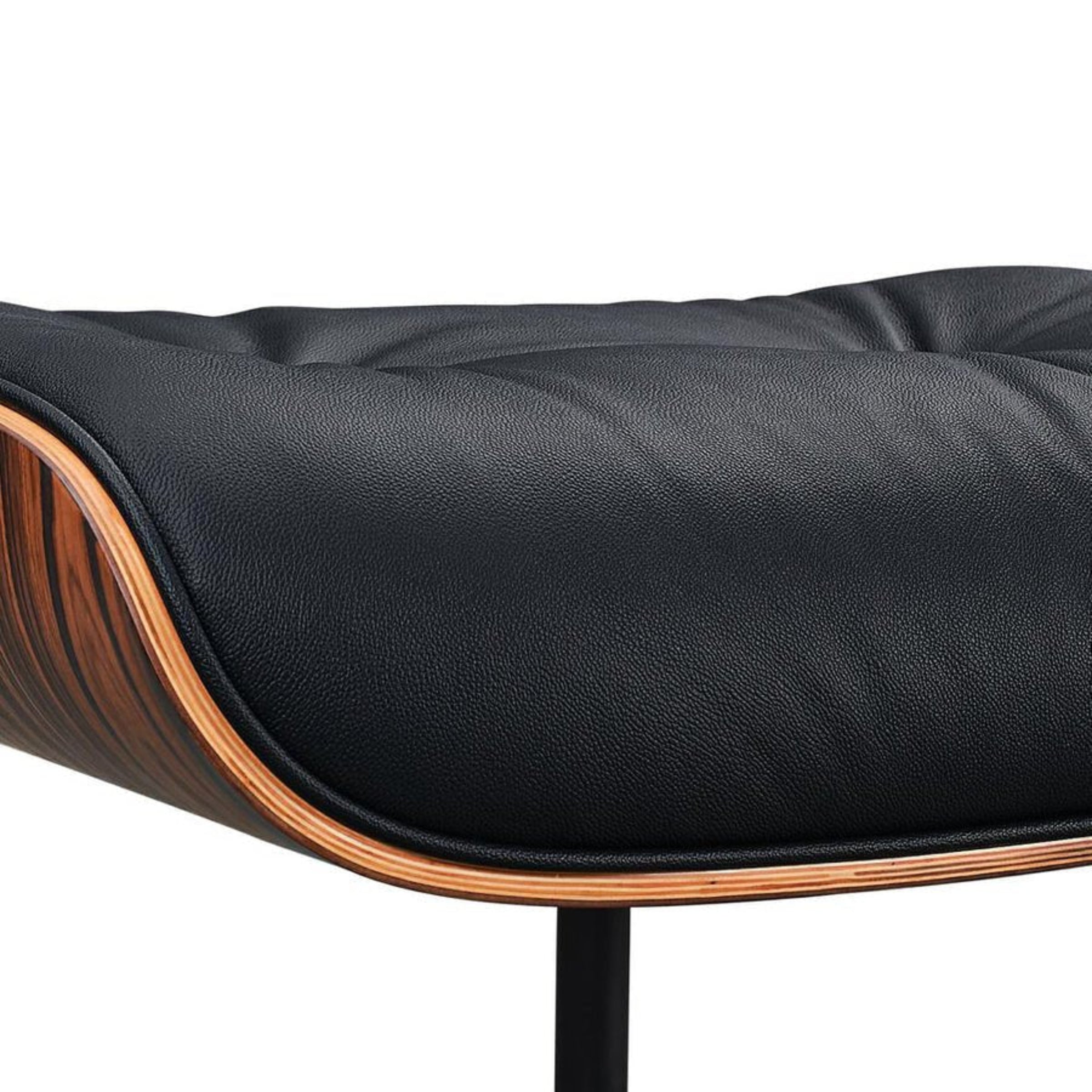Black leather chair with wooden armrests on a white background