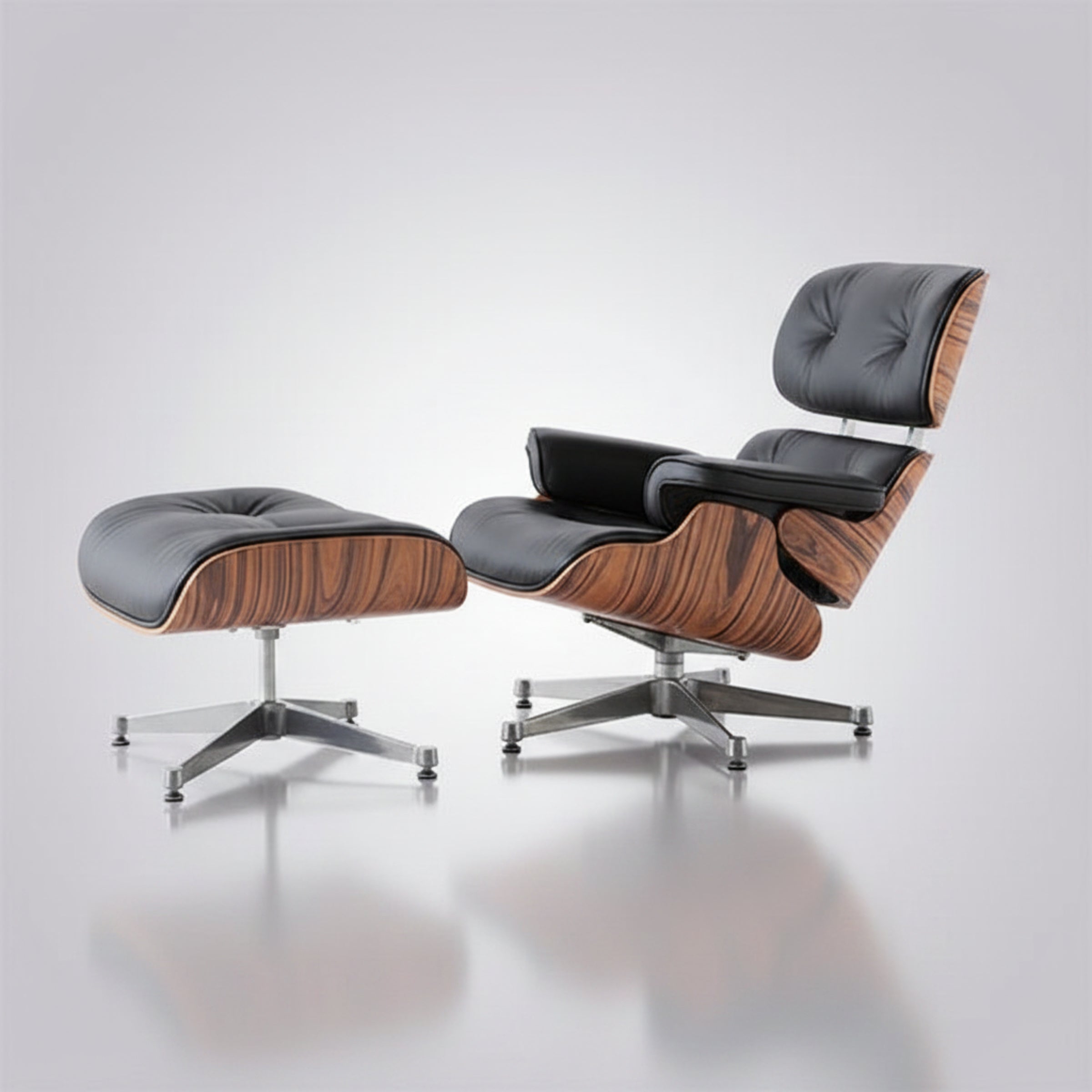 A mid-century modern lounge chair with an attached ottoman, featuring black leather upholstery