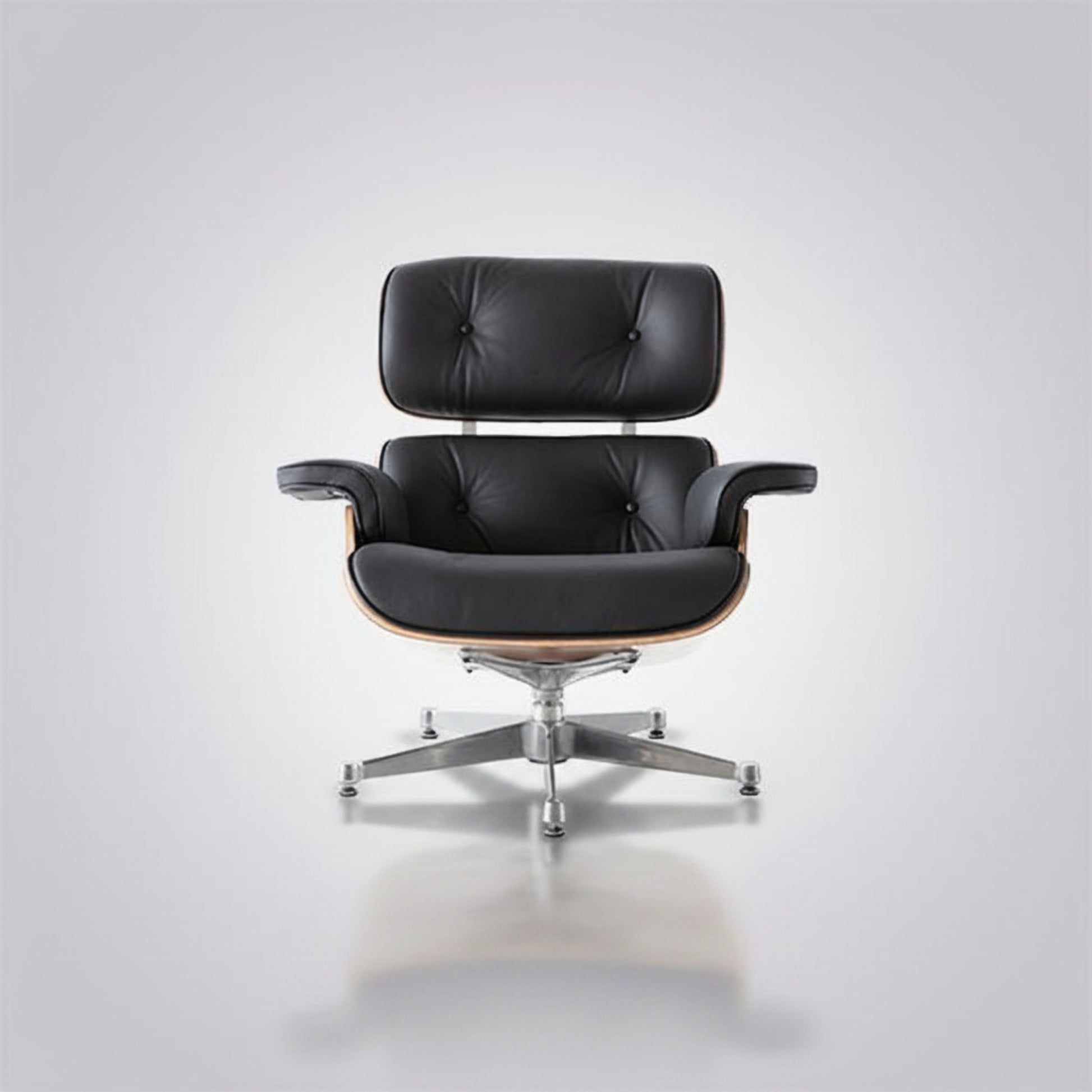 A classic mid-century modern lounge chair with black leather upholstery, a curved wooden frame