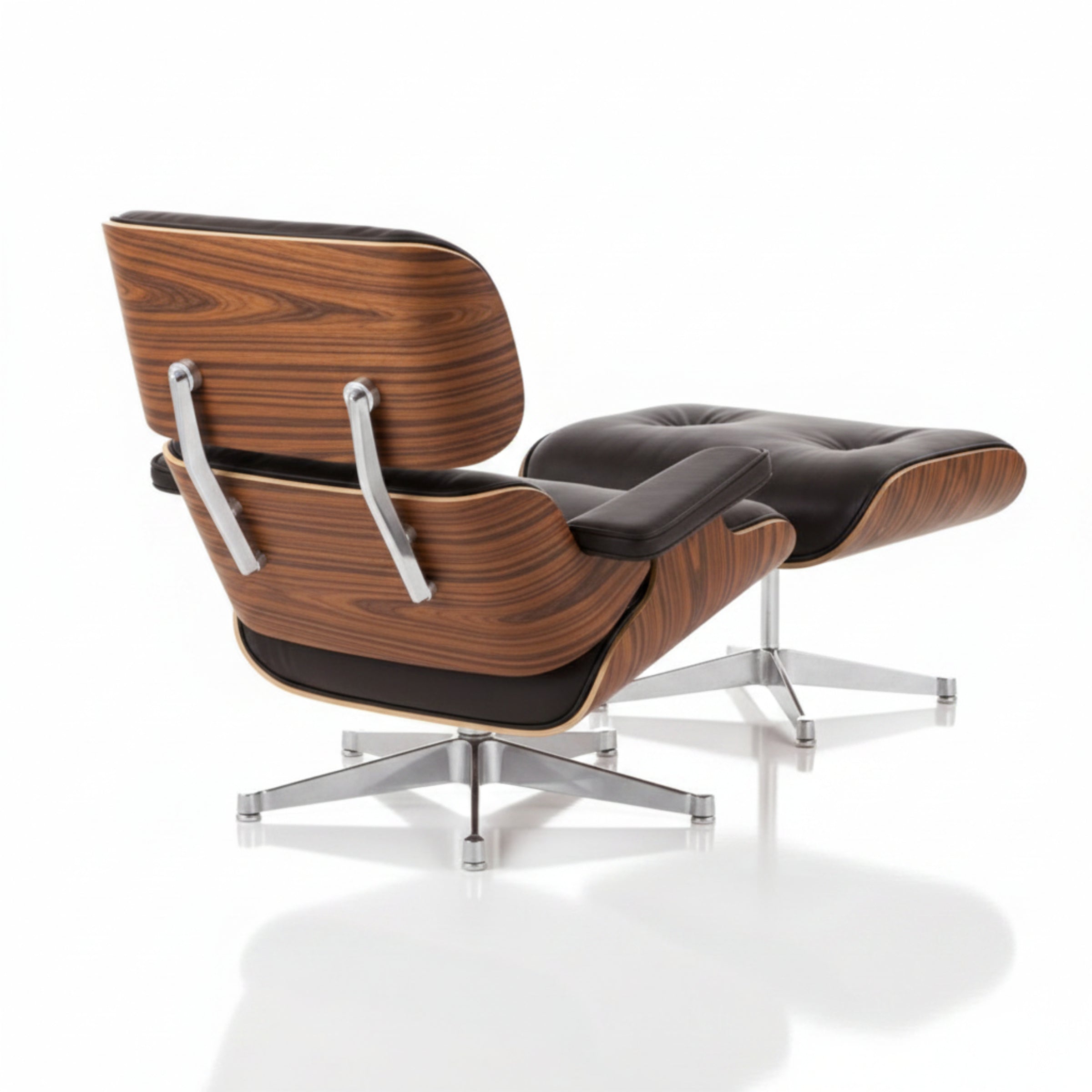 A mid-century modern lounge chair with an attached ottoman, featuring a dark brown wood grain shell