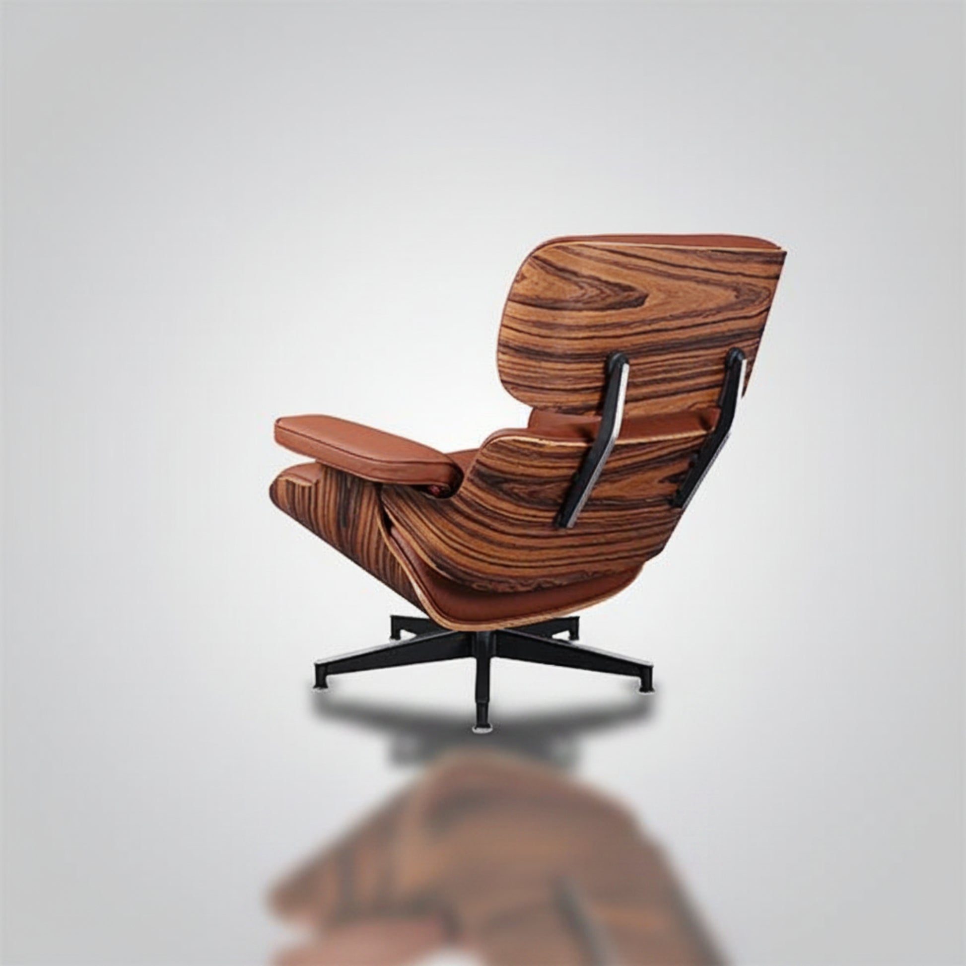 A mid-century modern lounge chair with a rich brown wood grain patterned shell, brown leather armrest and seat cushion