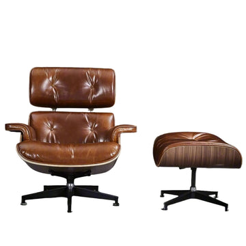 Brown leather armchair and ottoman on a white background