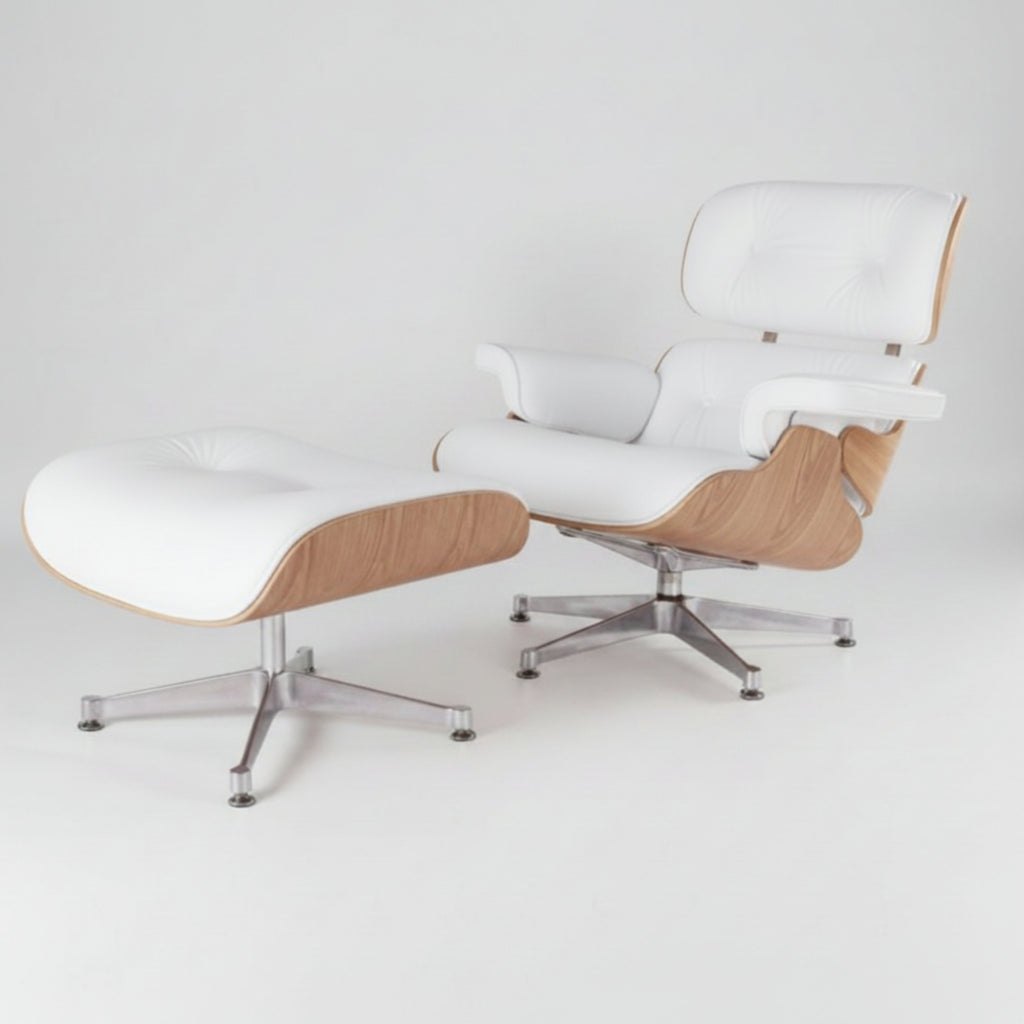 A modern lounge chair with a matching ottoman, featuring white leather upholstery, light wood grain sides