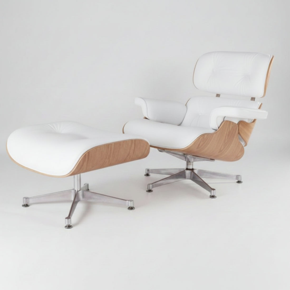 A modern lounge chair with a matching ottoman, featuring white leather upholstery, light wood grain sides