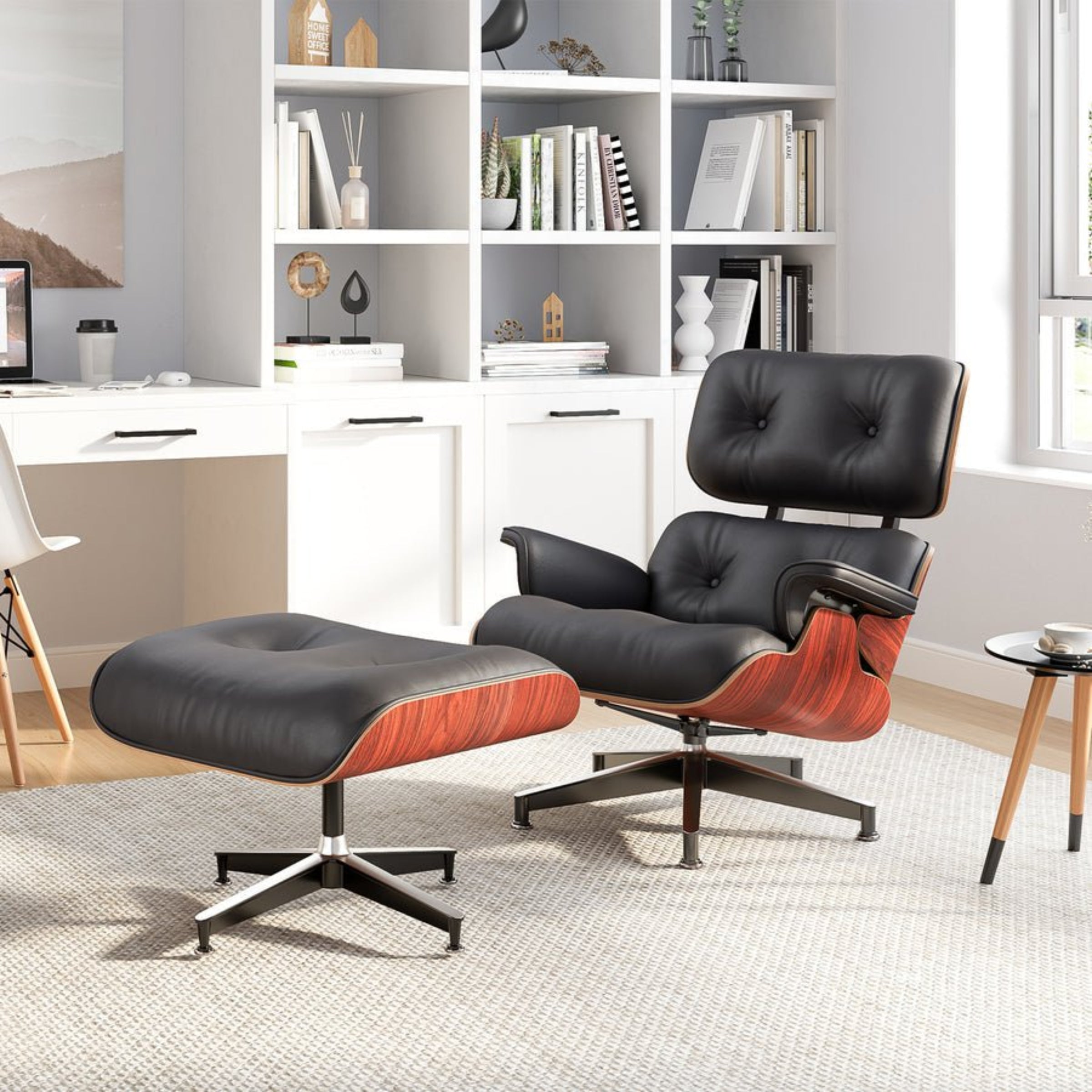 Black leather Eames-style chair and ottoman in a modern office setting with bookshelves.
