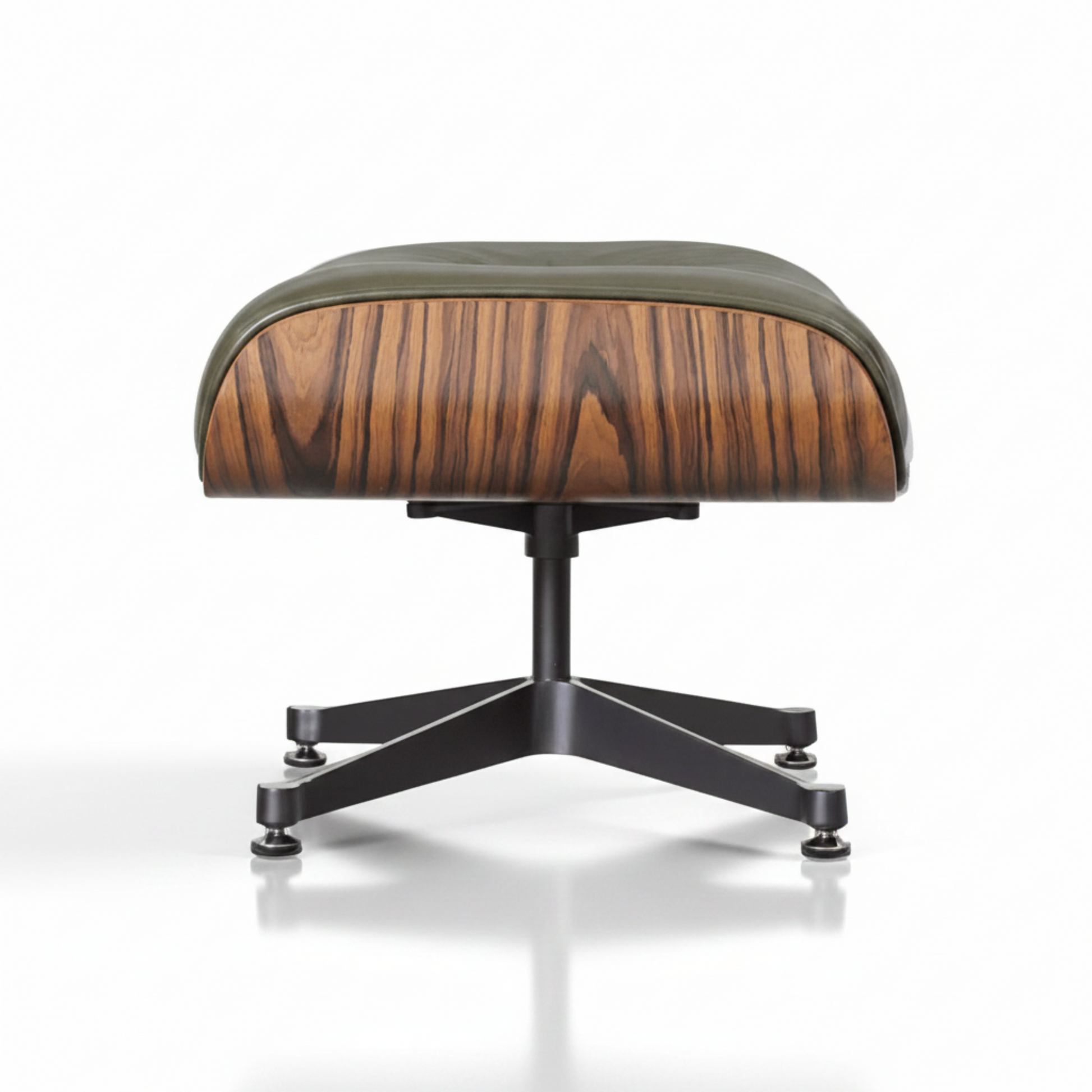 A modern lounge ottoman with a curved seat upholstered in olive green leather