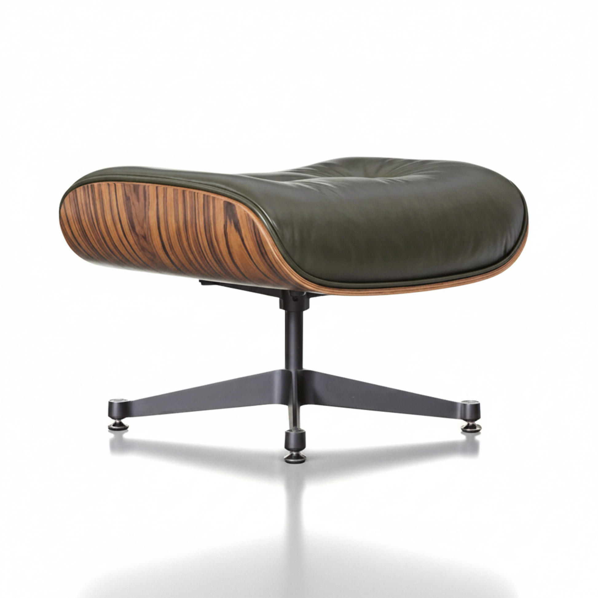 A mid-century modern lounge chair with a dark olive green leather cushion, a curved wooden shell with visible wood grain