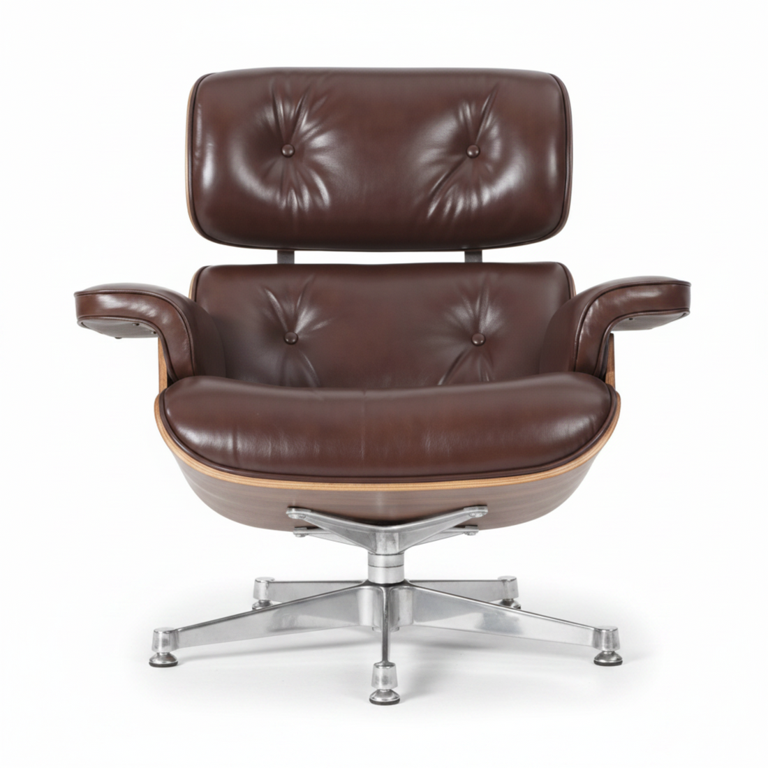 A mid-century modern lounge chair with matching ottoman on a white reflective studio background.