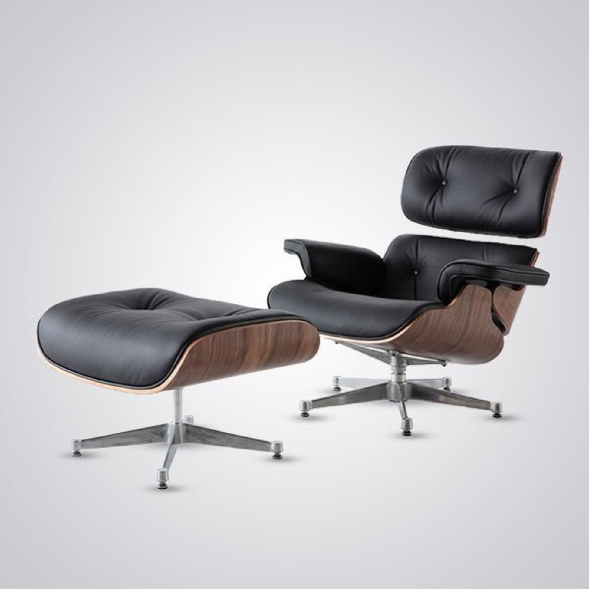 Black leather lounge chair and ottoman on a white background